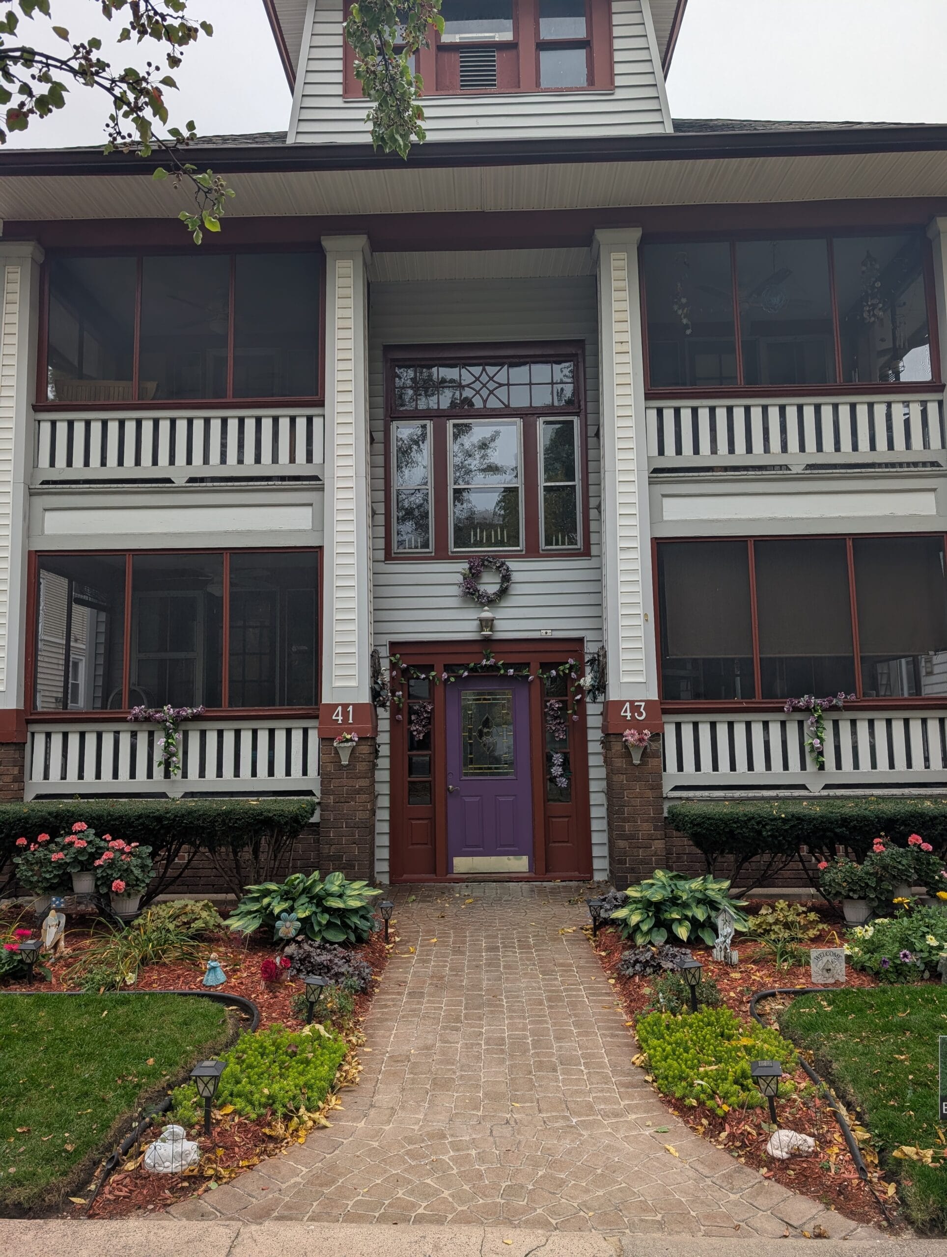 Fully maintained front yard with gardens and sealed paver walkway in Rochester NY