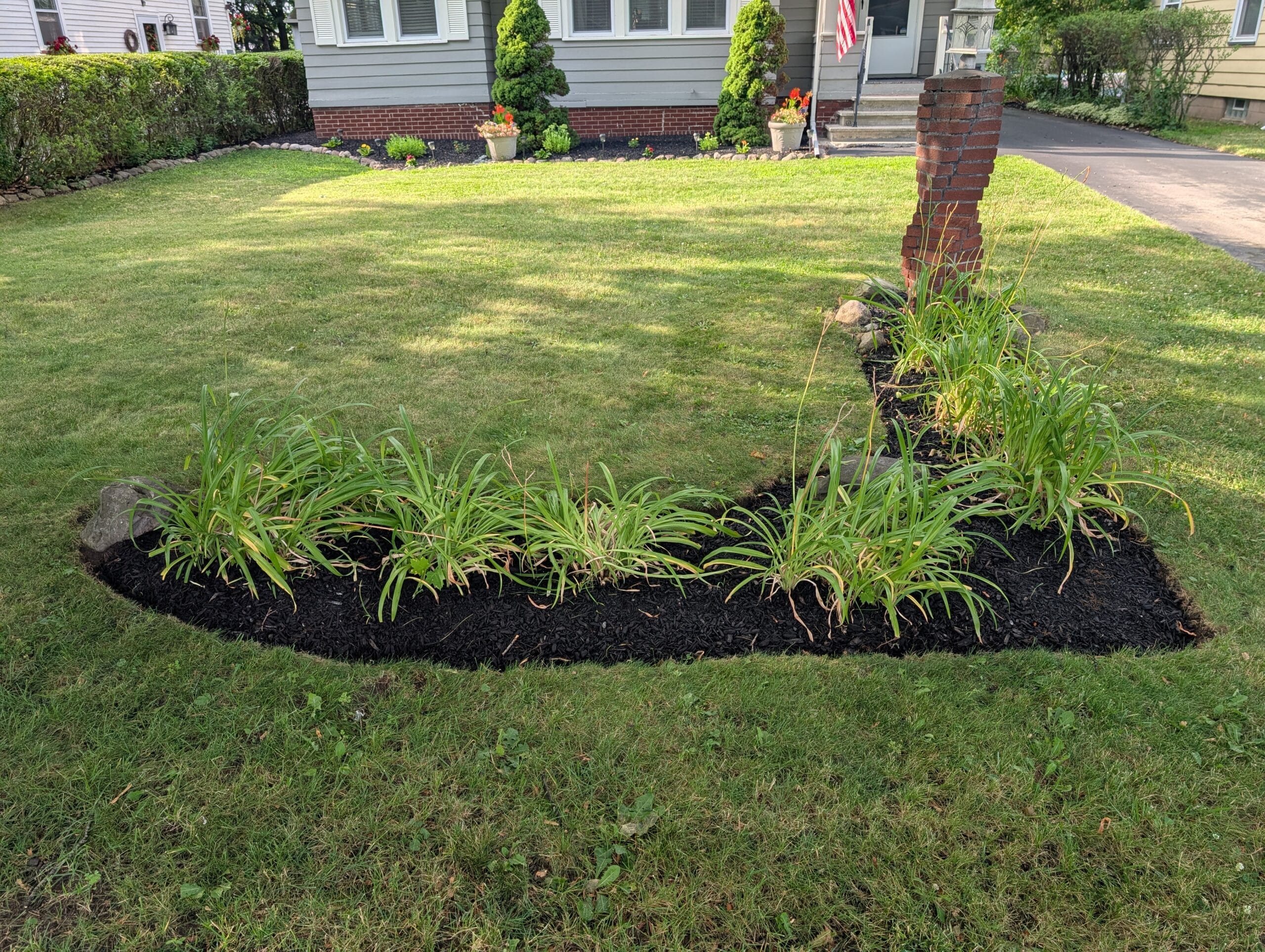 Close-up of clean garden edging after lawn mowing in Irondequoit NY
