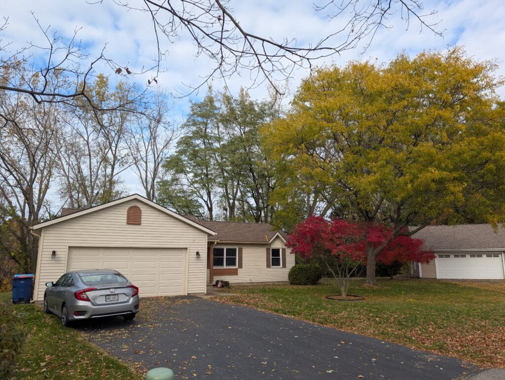 Front yard covered in leaves before leaf blowing and removal in Irondequoit NY