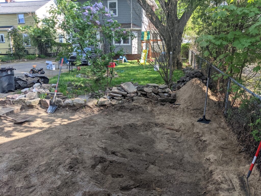 Completely filled pond in Irondequoit ready for patio installation.